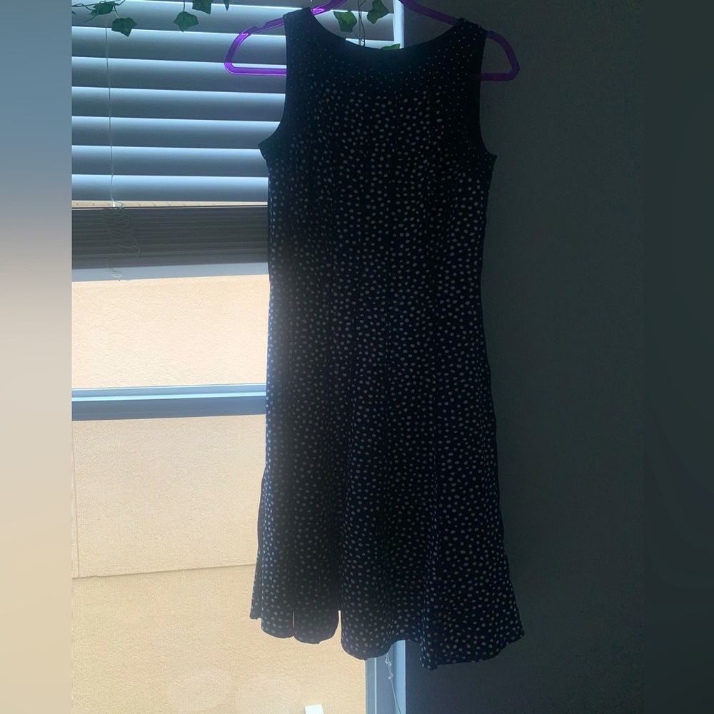This Perceptions dress is navy blue with white polka dots. It’s a small.